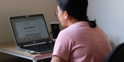 A woman working remotely from her home working set-up