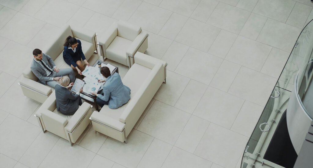 fair work agency people having meeting in bright atrium